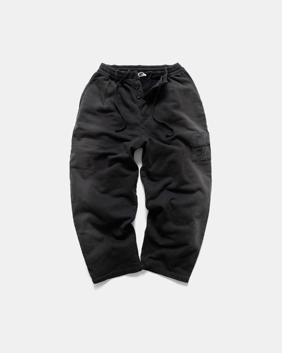 Men's heavyweight sweatpants in black, front view with button fly