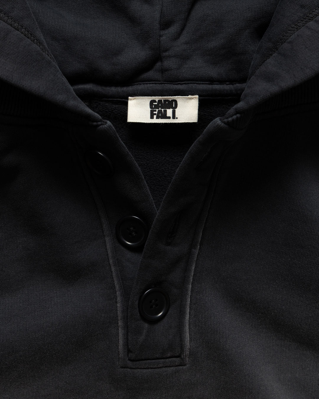 Men's heavyweight hoodie in black, corozo button placket and label detail