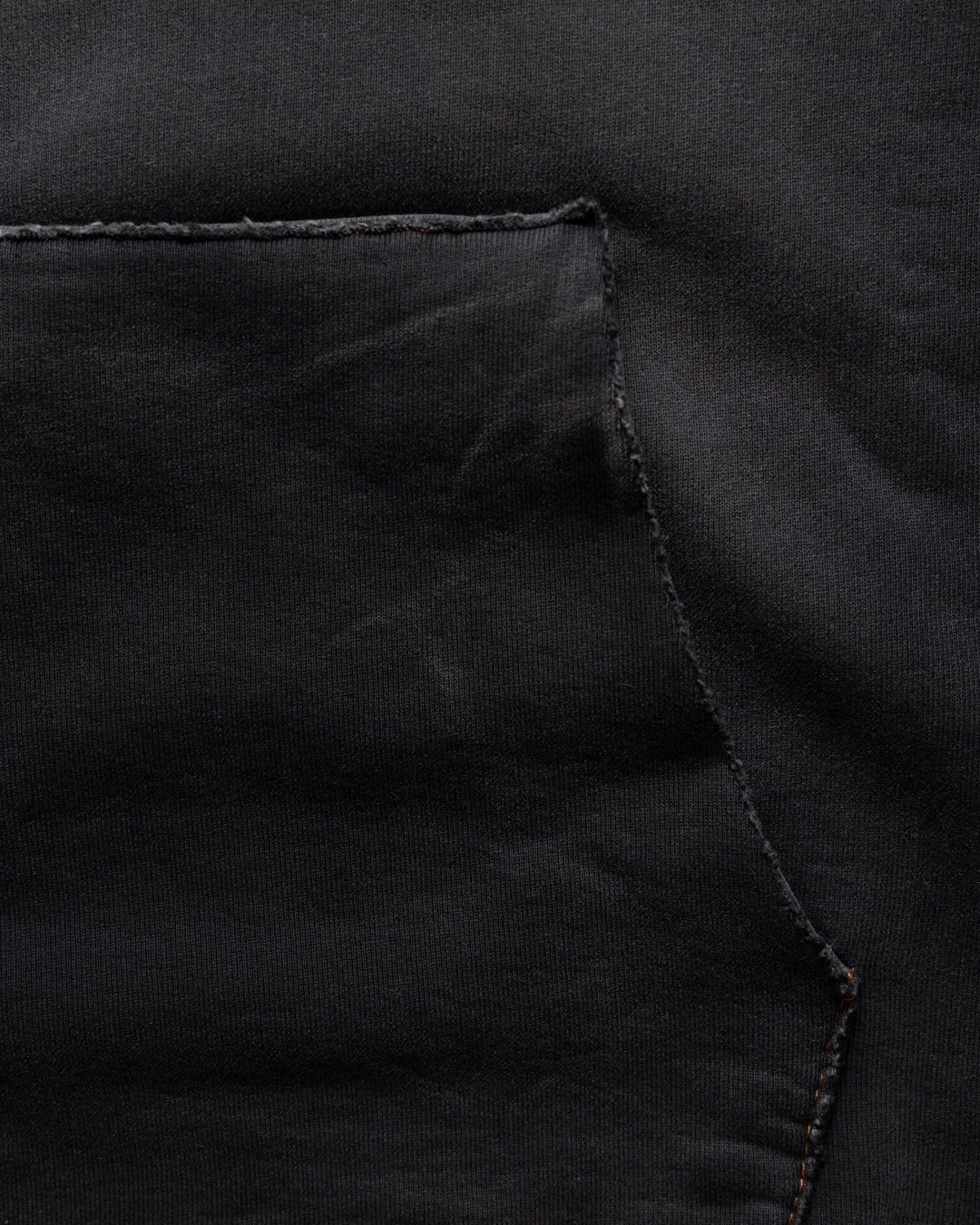 Men's heavyweight hoodie in black, raw-edged kangaroo pocket detail